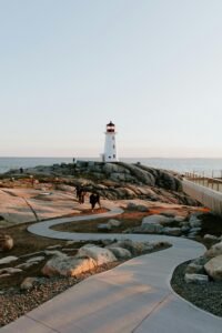 A winding pathway leads to the iconic Peggys Cove Lighthouse in Nova Scotia.